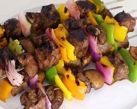 Steak Kabob with vegetables over rice